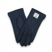Navy herringbone Harris Tweed gloves worn holding enamel mug on Scottish moorland