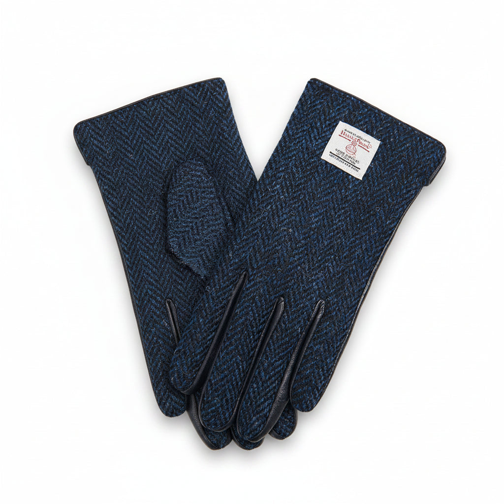 Navy herringbone Harris Tweed gloves worn holding enamel mug on Scottish moorland