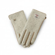 Harris Tweed cream gloves worn holding steaming mug outdoors in Scottish countryside