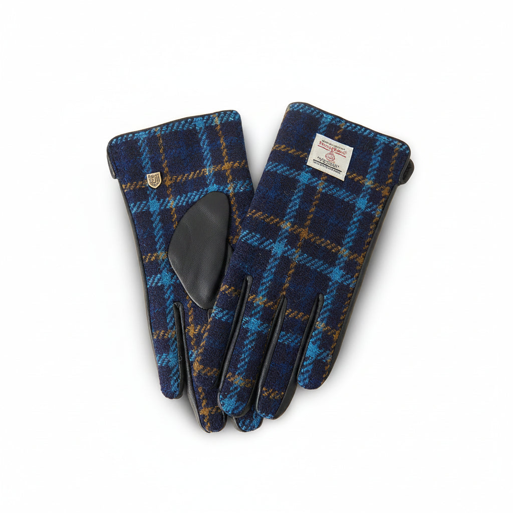 Navy tartan Harris Tweed glove gripping walking stick on Scottish hillside