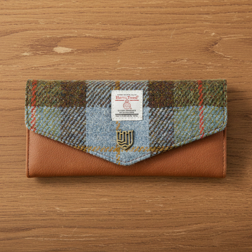 Chestnut and blue tartan Harris Tweed clasp purse on wooden surface
