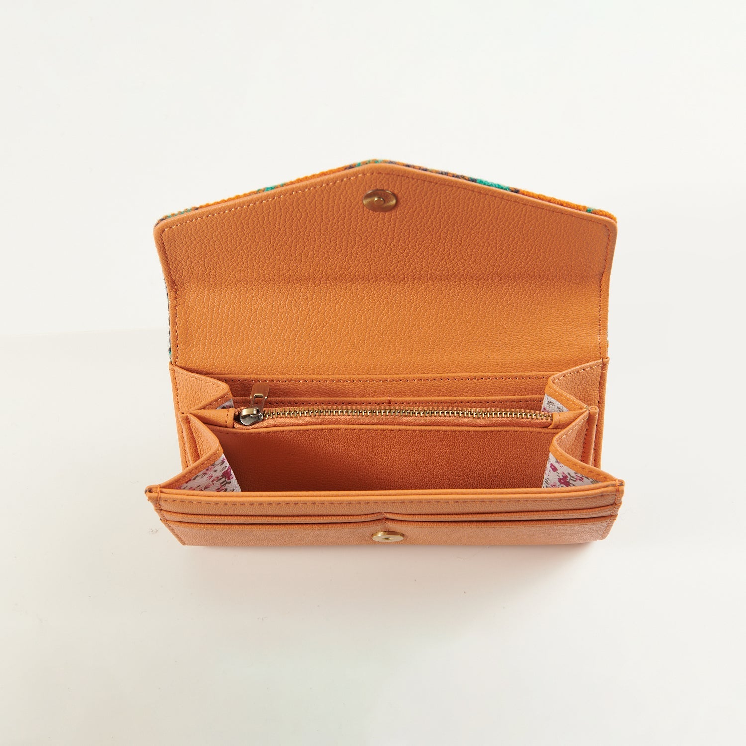 Orange clasp purse open, showing the lined card and note sections