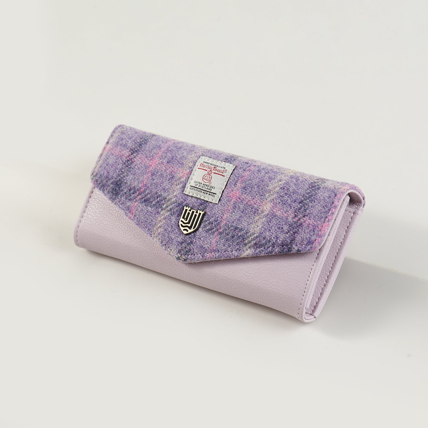 Lilac Harris Tweed clasp purse at an angle showing the popper flap