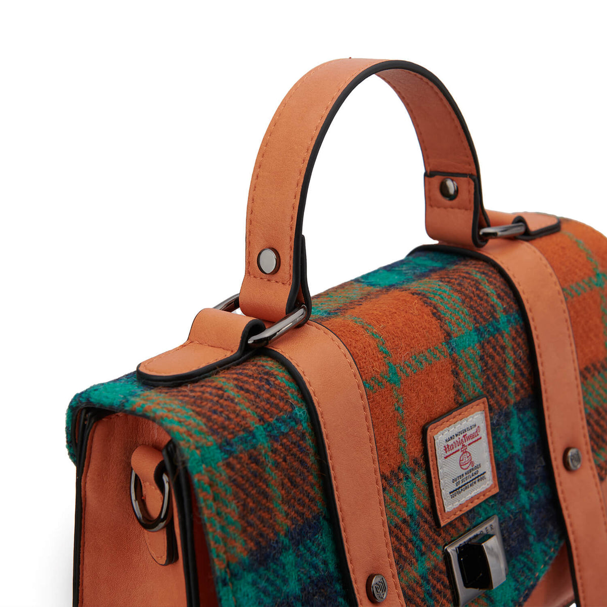 Close-up of the Islander satchel handle and hardware detailing against the vibrant orange and blue Harris Tweed fabric.