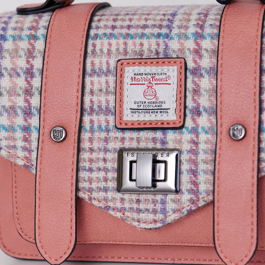 Close-up of Harris Tweed® label and twist lock fastening on Purple Pink Mini Satchel