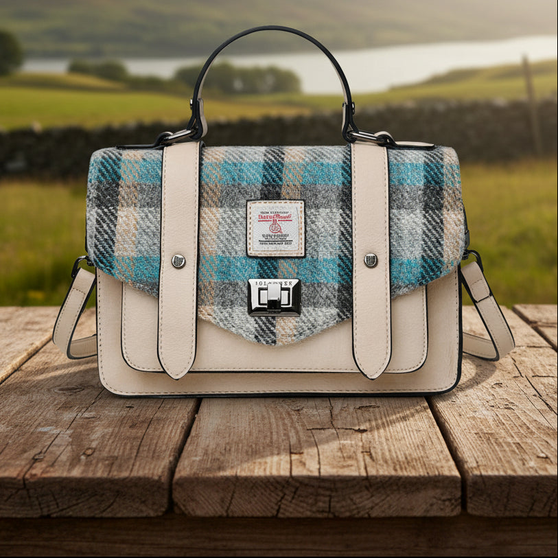 Islander Tartan Harris Tweed Satchel with a cream coloured PU leather body and shoulder strap behind.