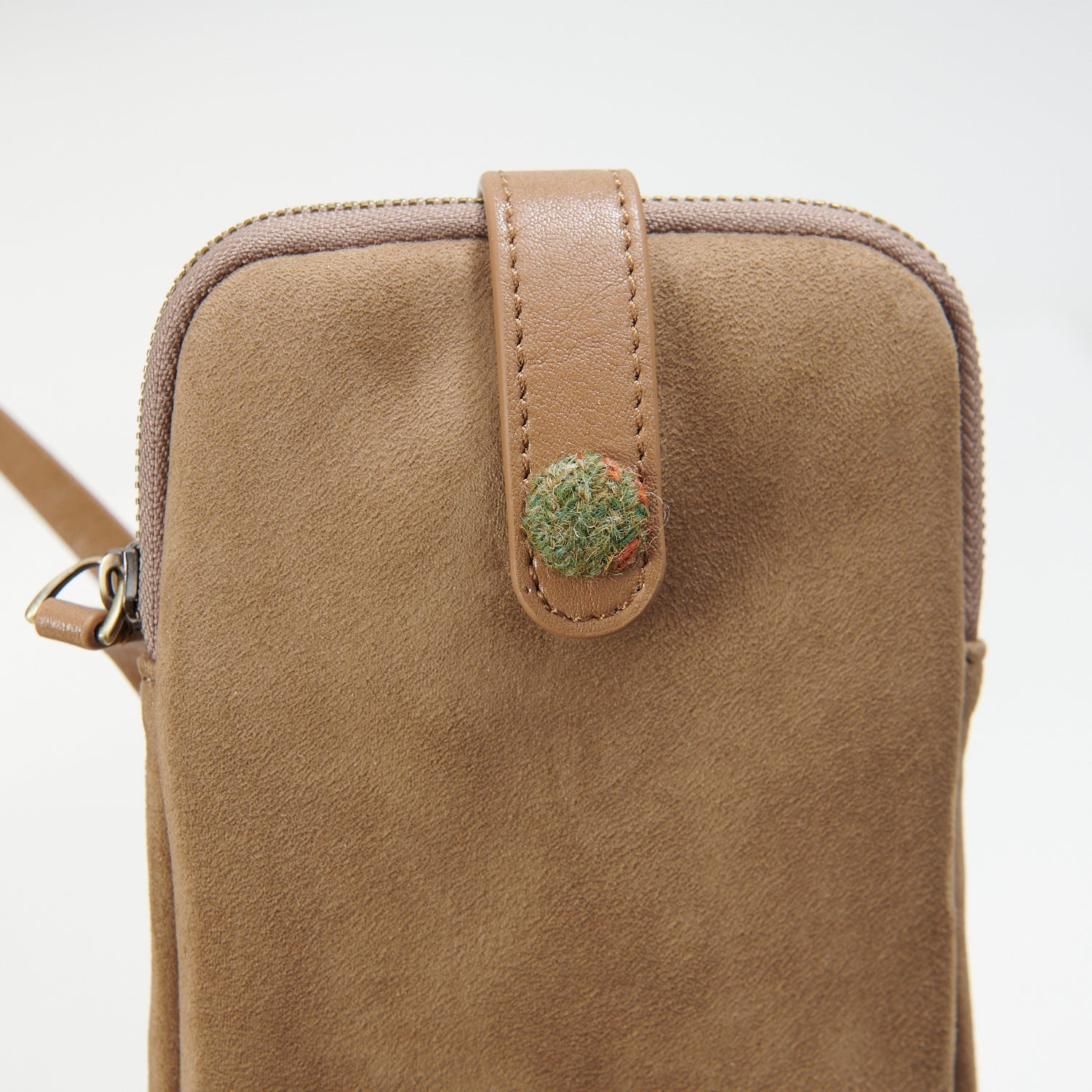 Islander phone pouch close-up showing suede texture and tartan detail