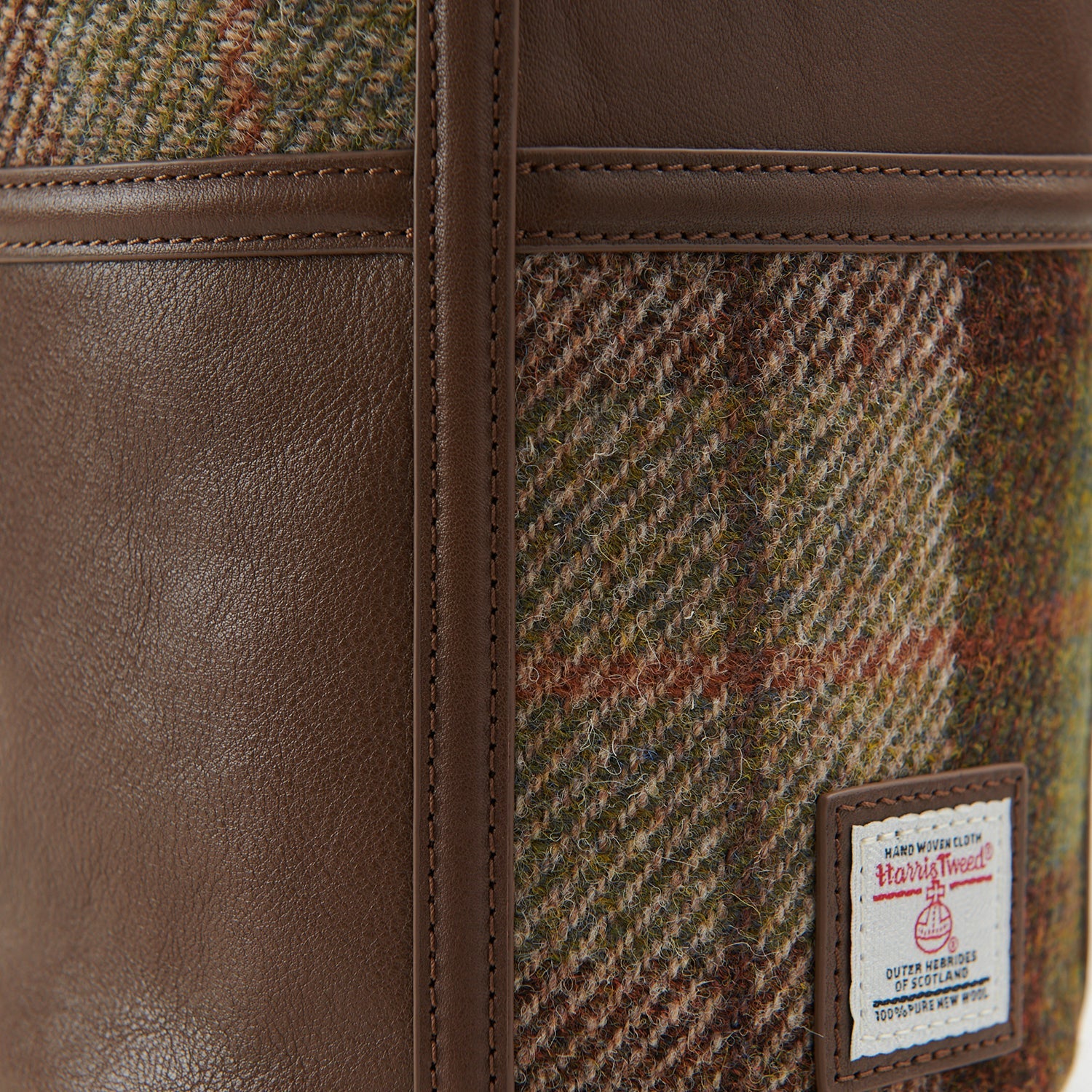 Close-up of chestnut tartan Harris Tweed pattern with certification label