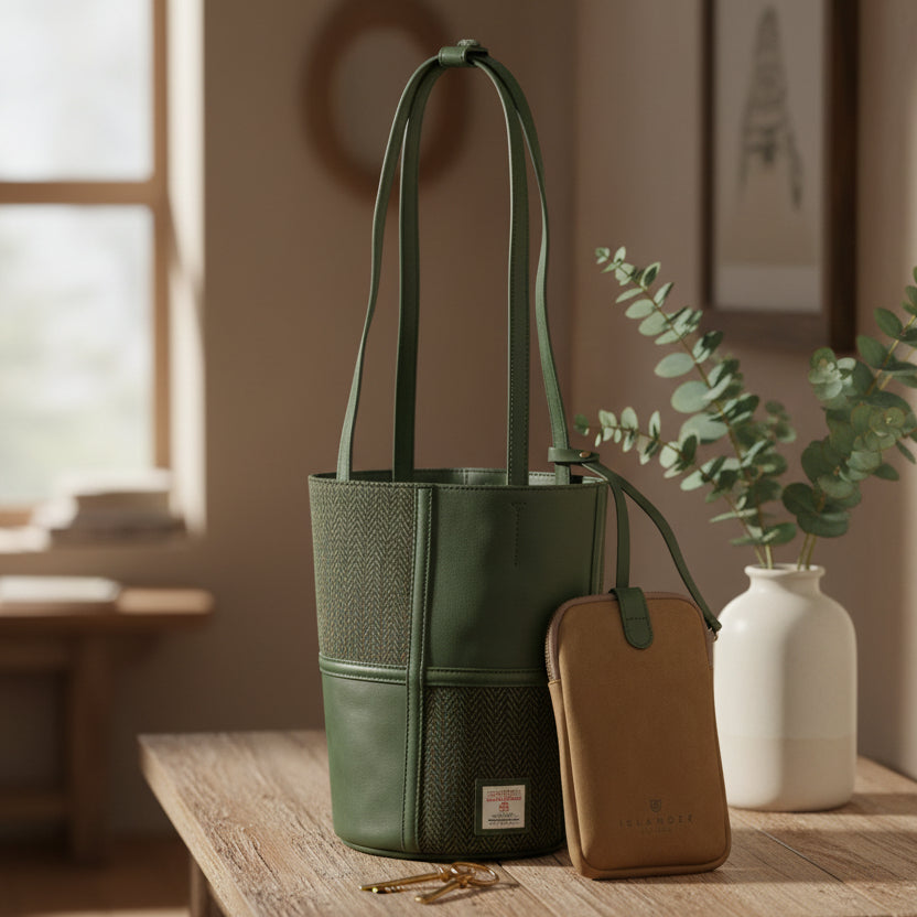 Orlagh green herringbone Harris Tweed bucket bag with pouch on wooden desk