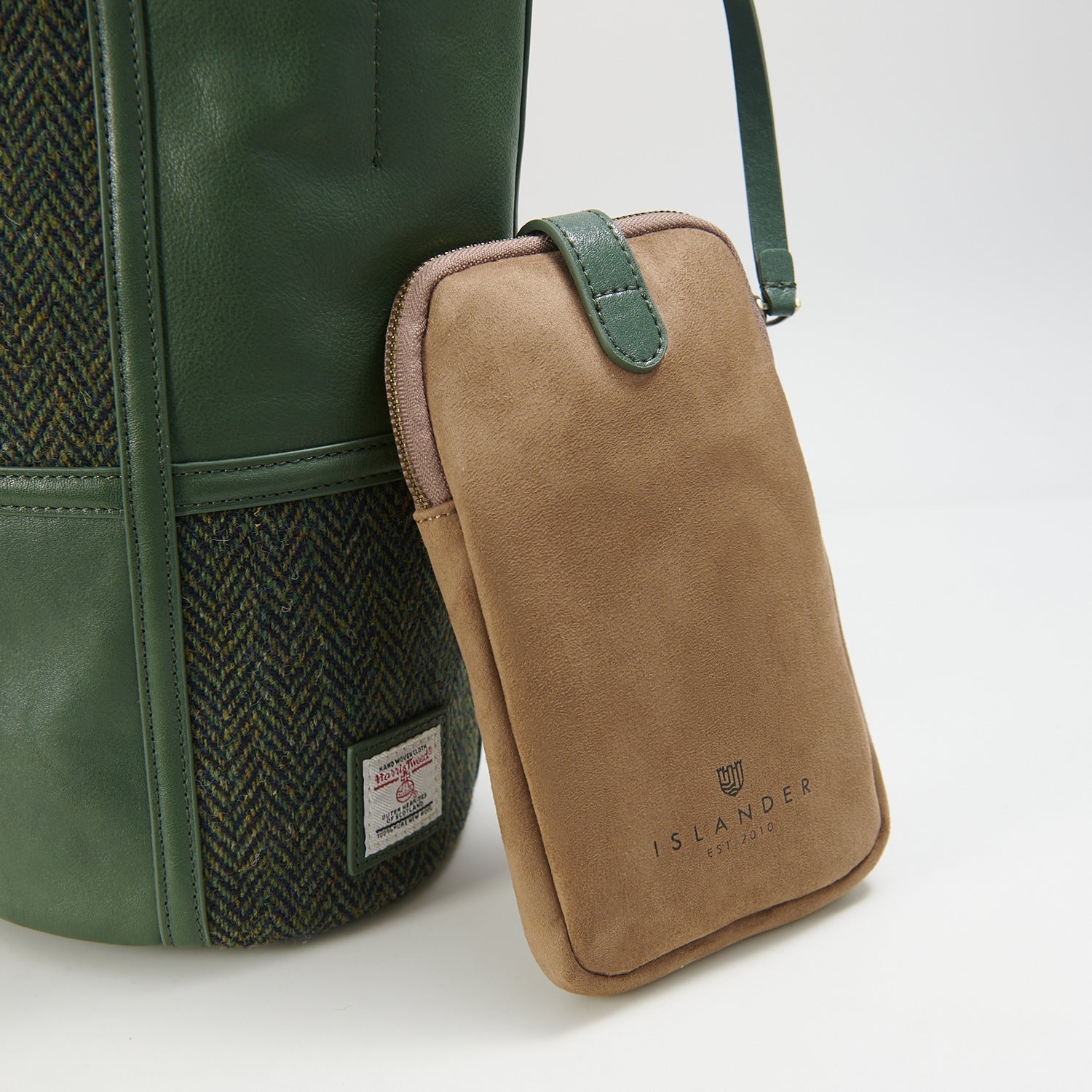 Green herringbone bucket bag side view with phone pouch on white background