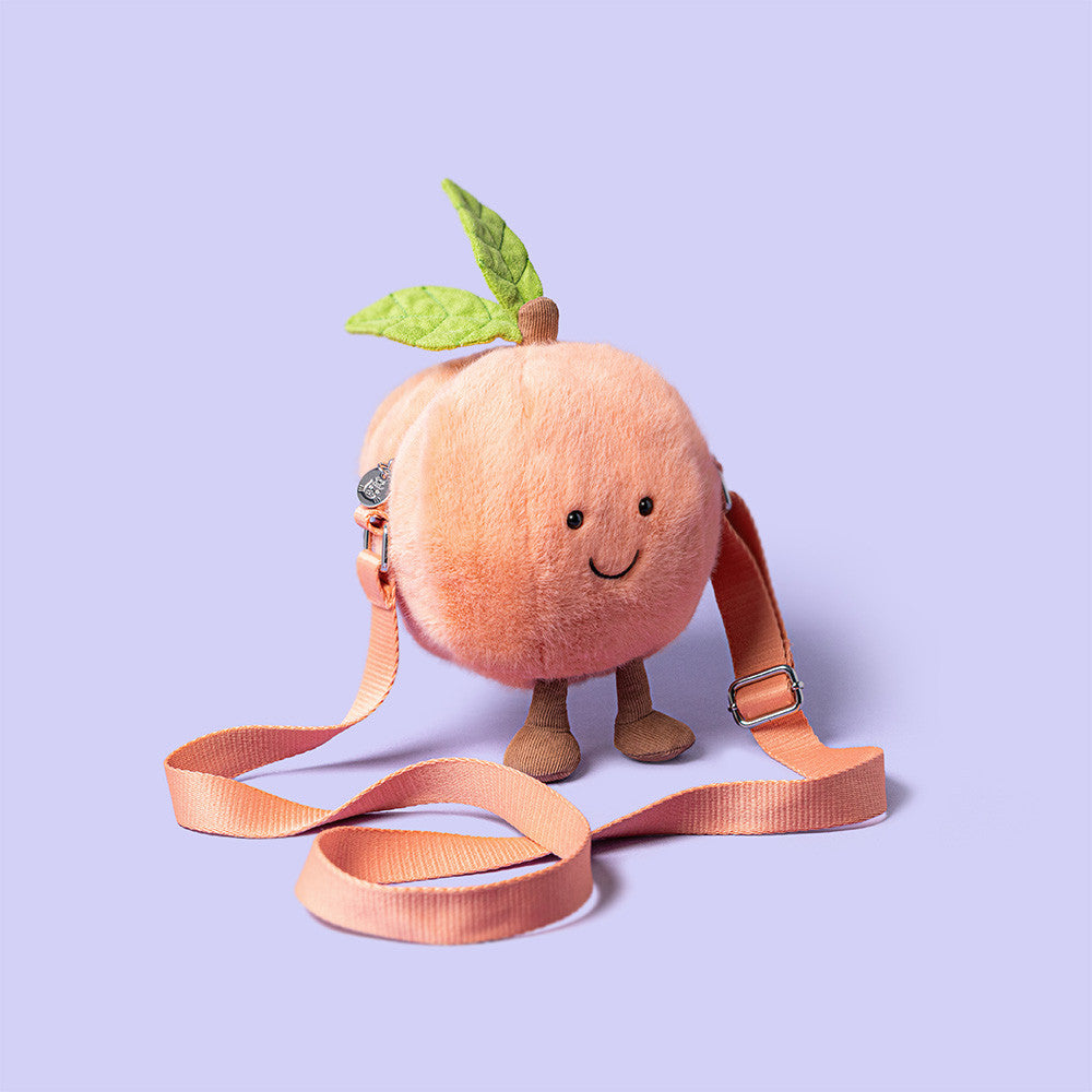Jellycat Peach Shoulder Bag with strap on lilac background
