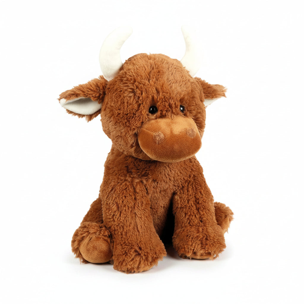 Brown Highland cow plush toy front view on white wooden background