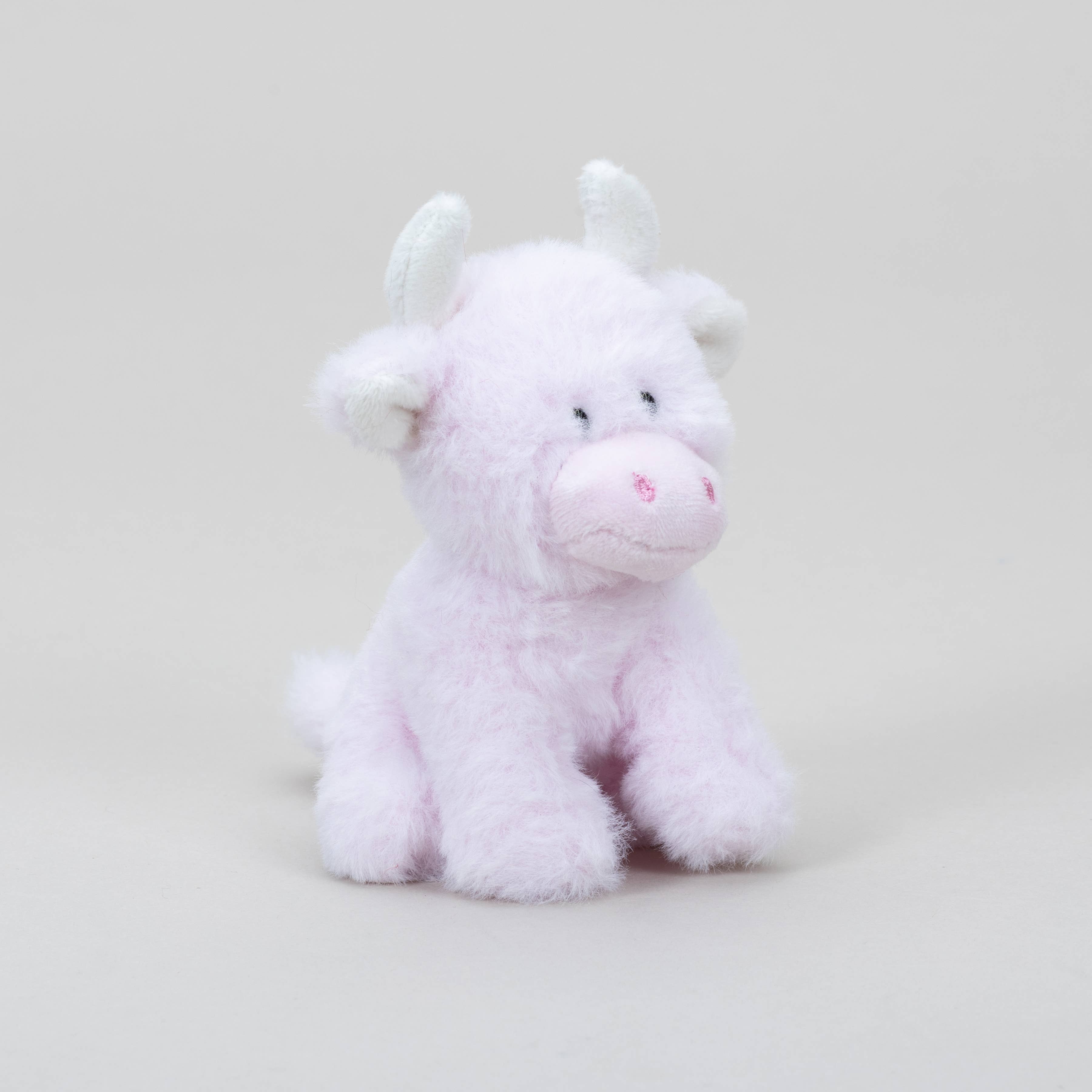 Pink highland cow COOllectible plush angled view on grey