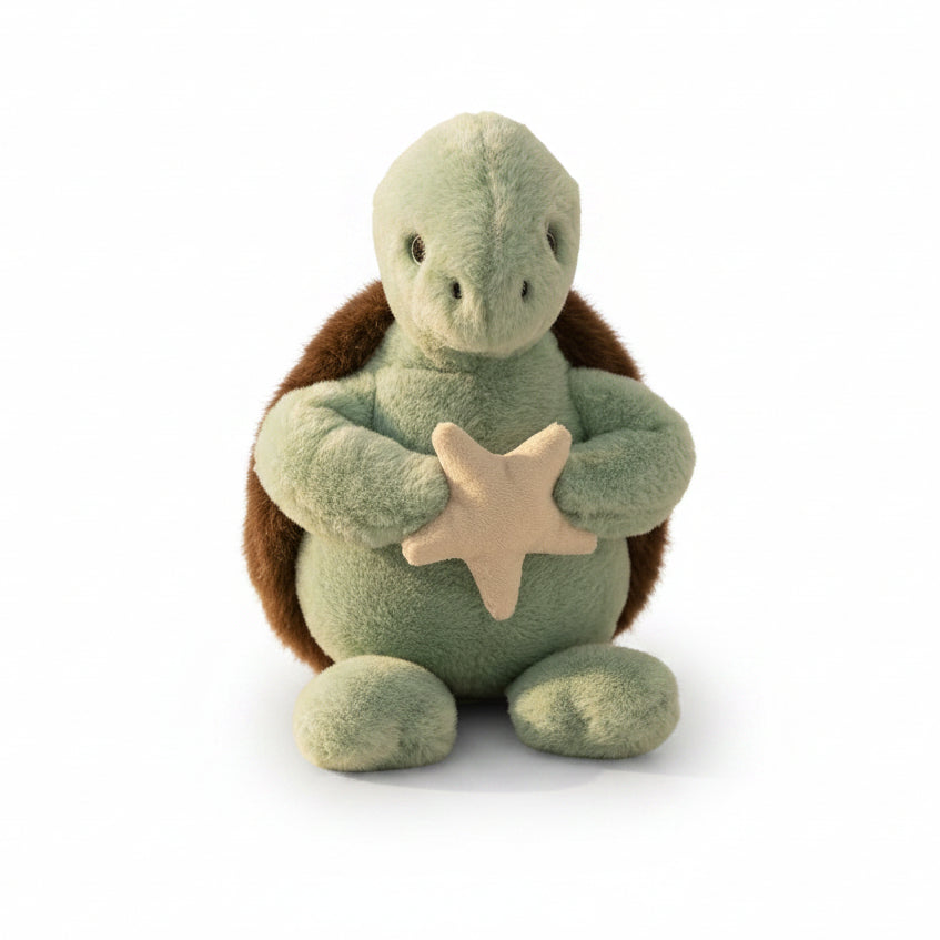 Jomanda sea turtle plush soft toy, 22cm, with a sage green body and brown shell, holding a cream starfish against its tummy.