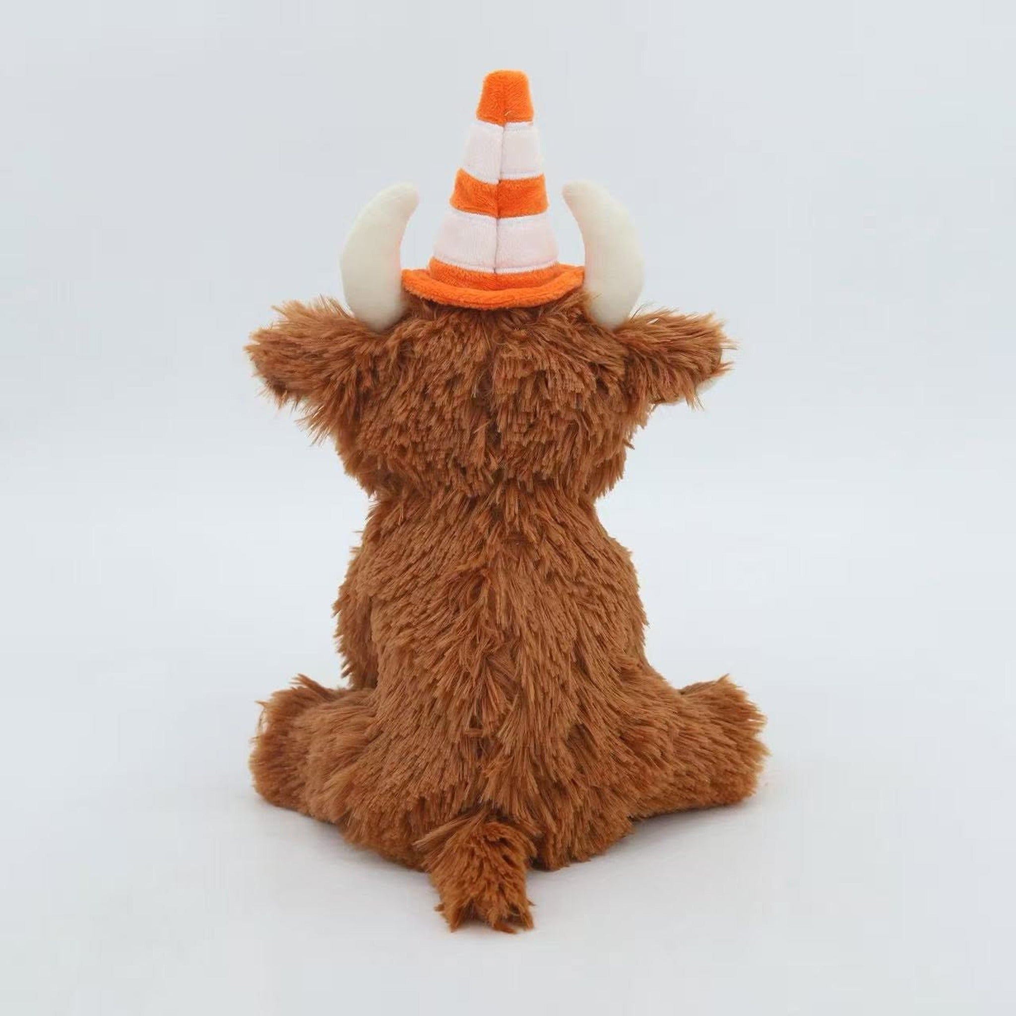 Back view of the traffic cone Highland cow plush showing shaggy brown fur