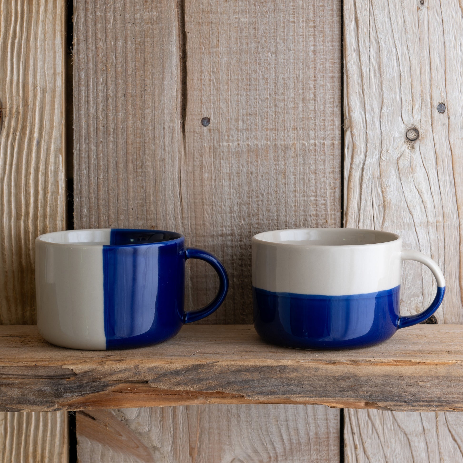 Indigo blue Rue mugs on a rustic wooden shelf
