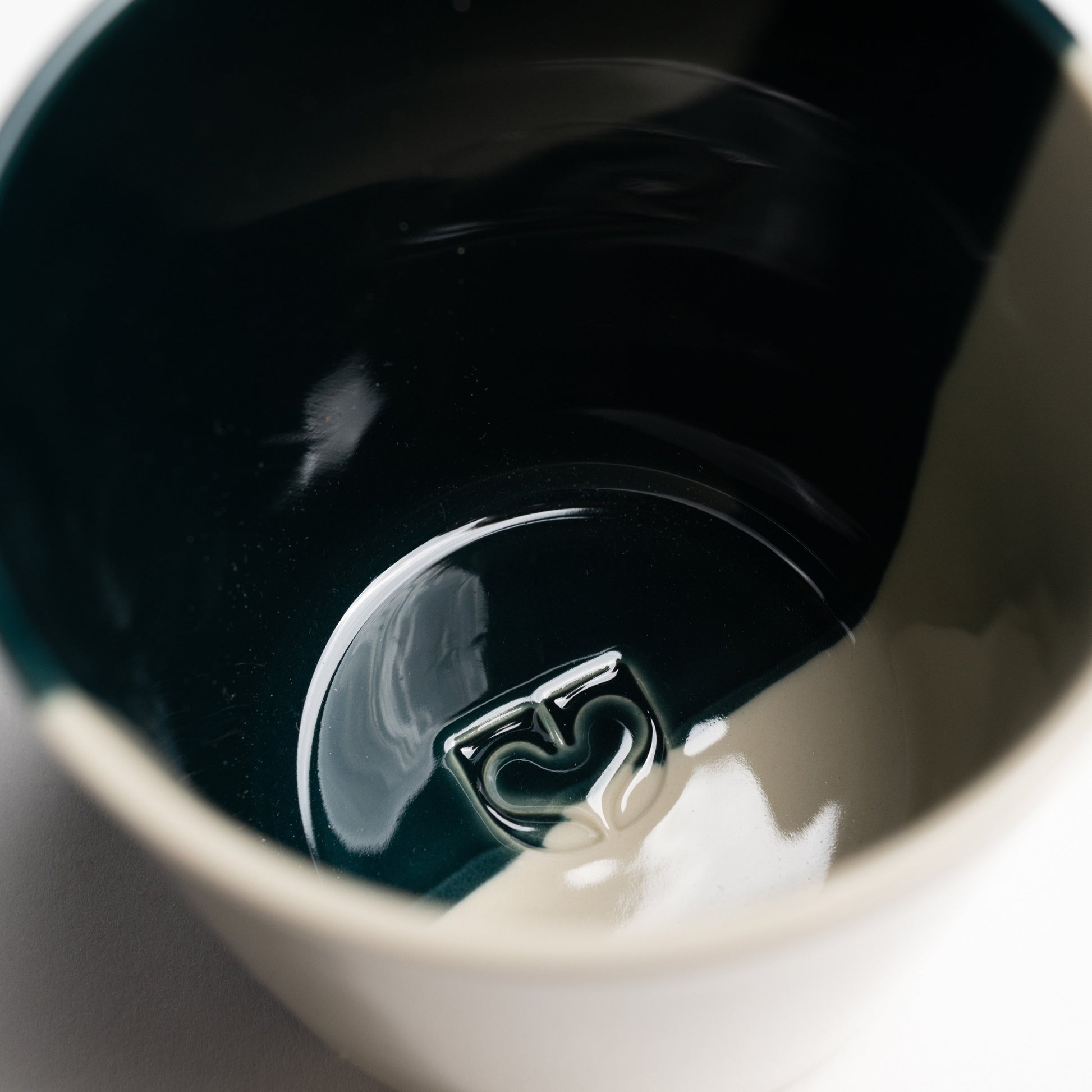 Close up inside a sea green Rue mug showing the glossy glaze