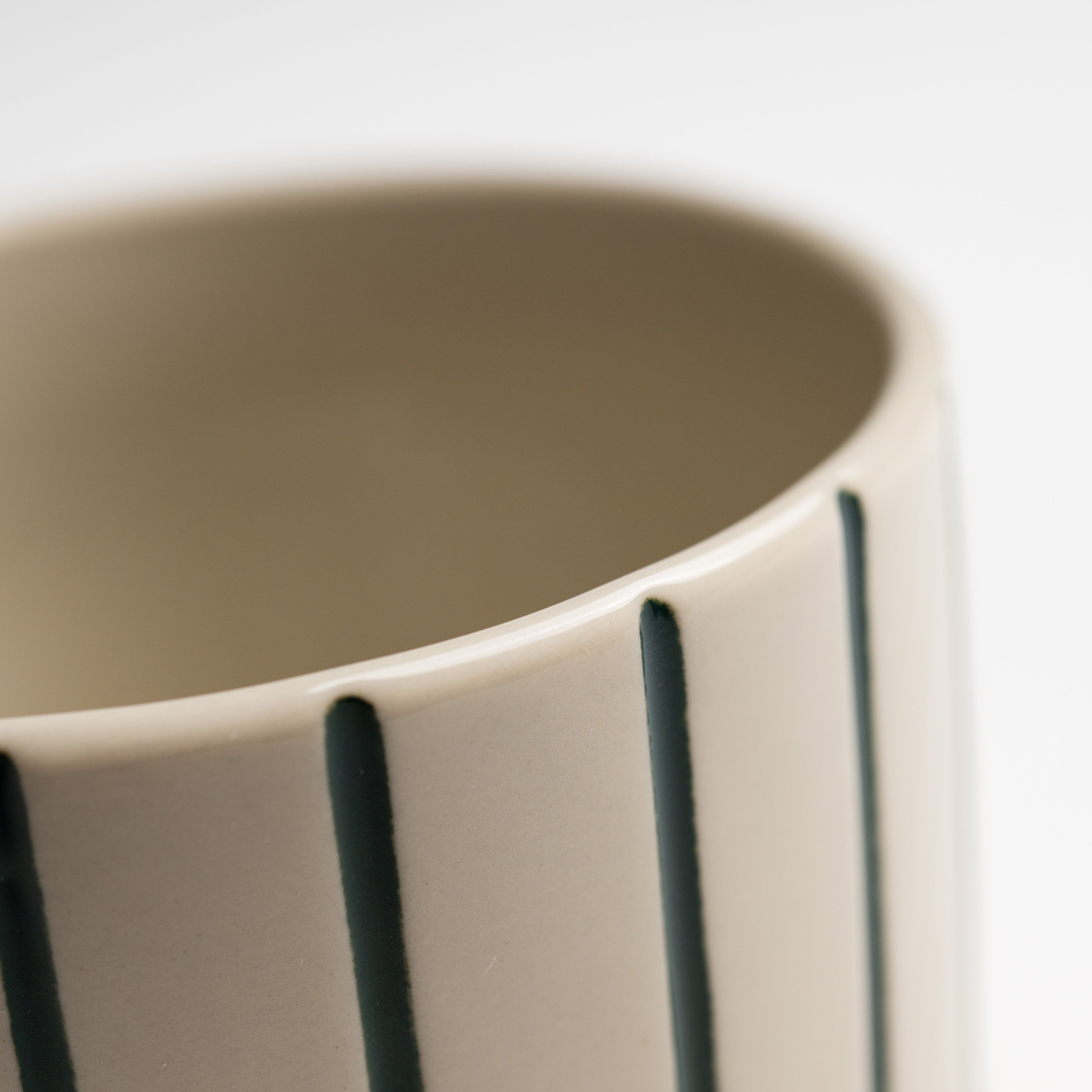 Close up of the hand-etched sea green linework on a Sorrel beaker