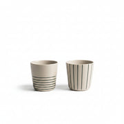 Two small sea green hand-etched Sorrel beakers on a white background