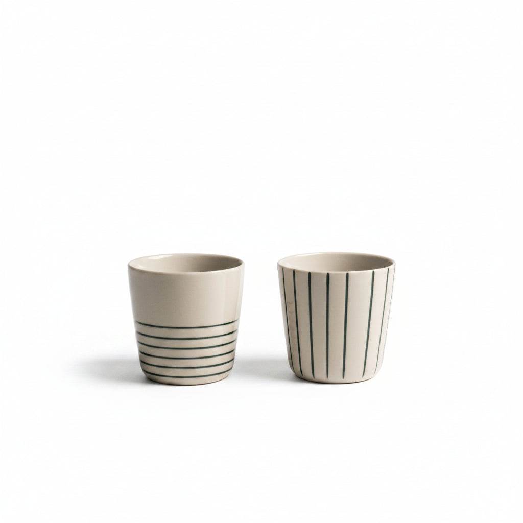 Two small sea green hand-etched Sorrel beakers on a white background