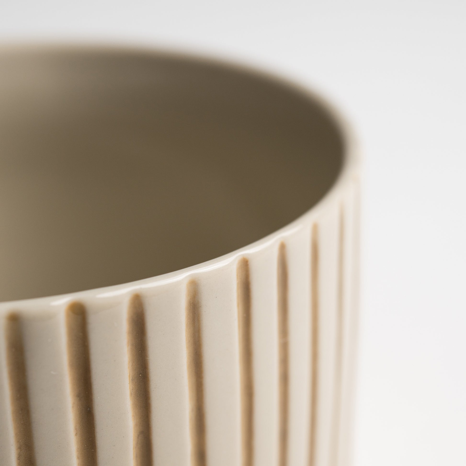 Close up of the hand-etched mustard linework on a Yarrow mug
