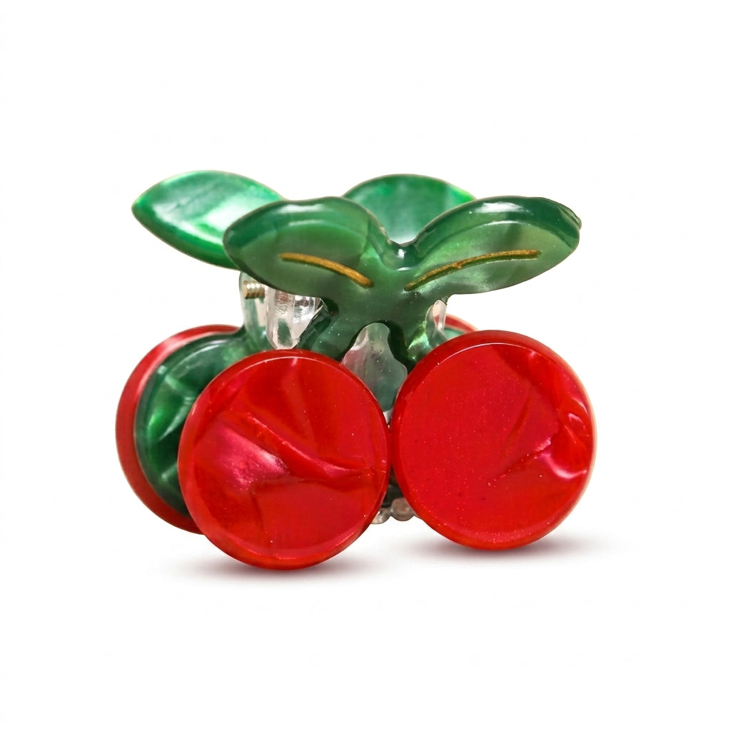 Mini red cherry hair clip on a white background