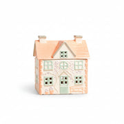Peach-roofed ceramic cottage wax burner with painted windows and chimneys
