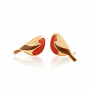 Pair of gold robin stud earrings with red enamel breasts on cream fabric