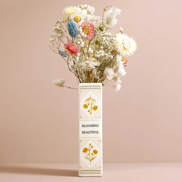 Spine view of book vase showing Blooming Beautiful text with dried flowers