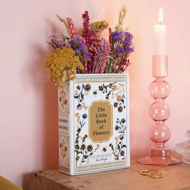 Floral book vase styled with dried flowers on wooden shelf with pink candle