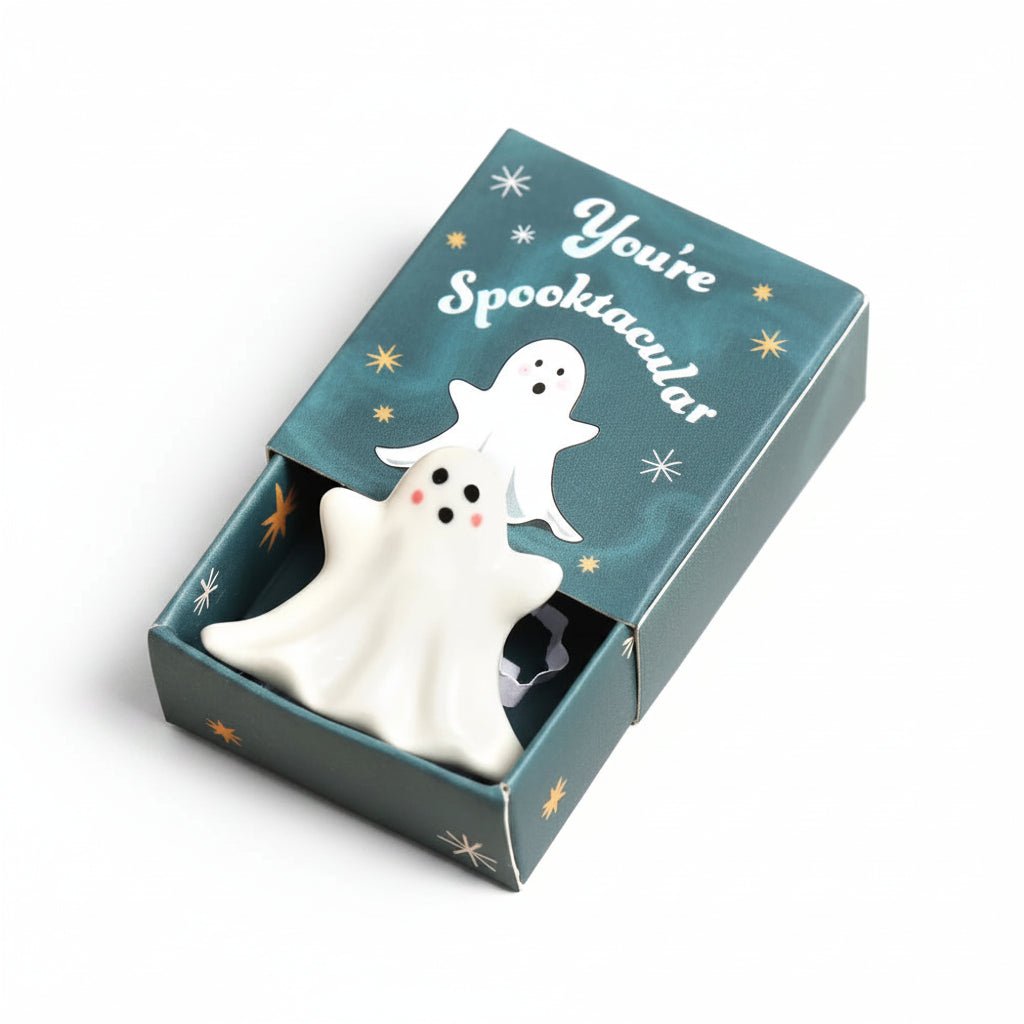 Ceramic ghost token in an open teal You're Spooktacular matchbox