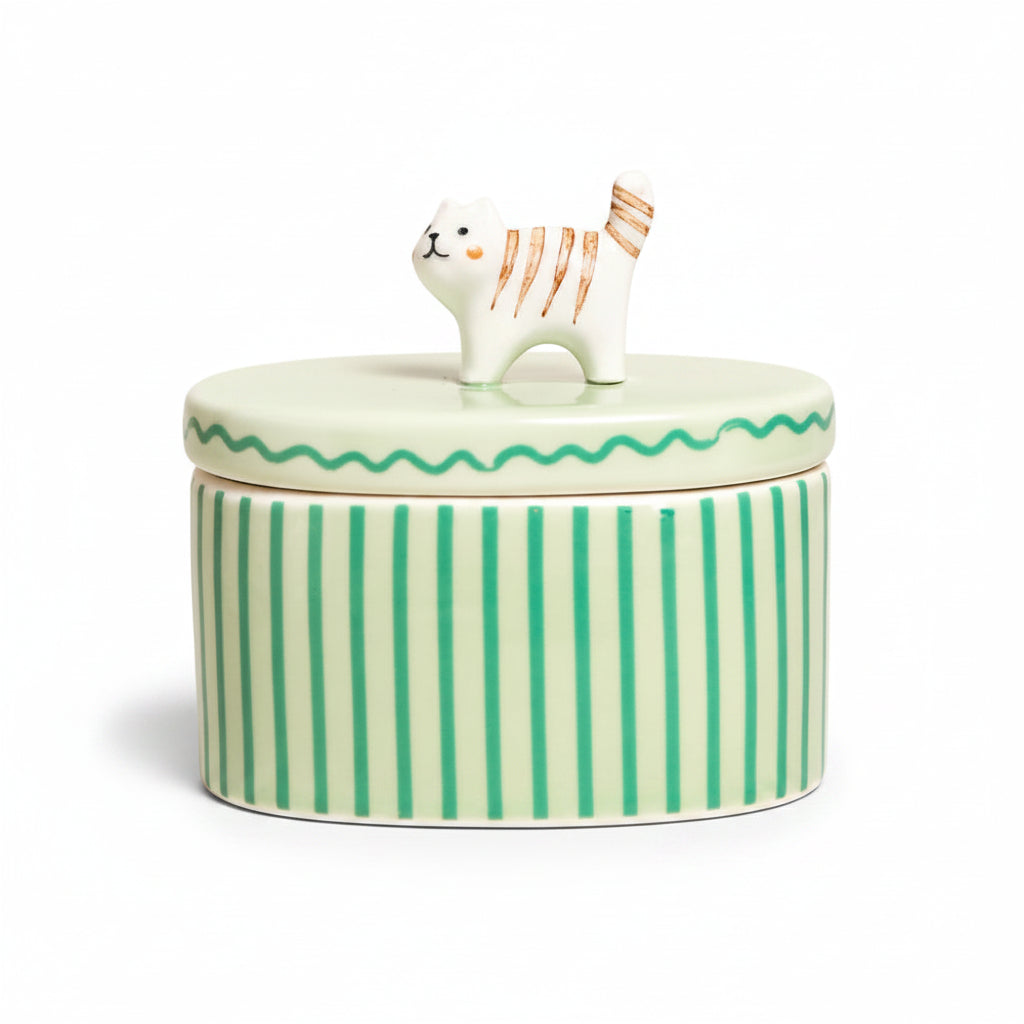 Mint green striped ceramic trinket pot with a tabby cat sitting on the lid