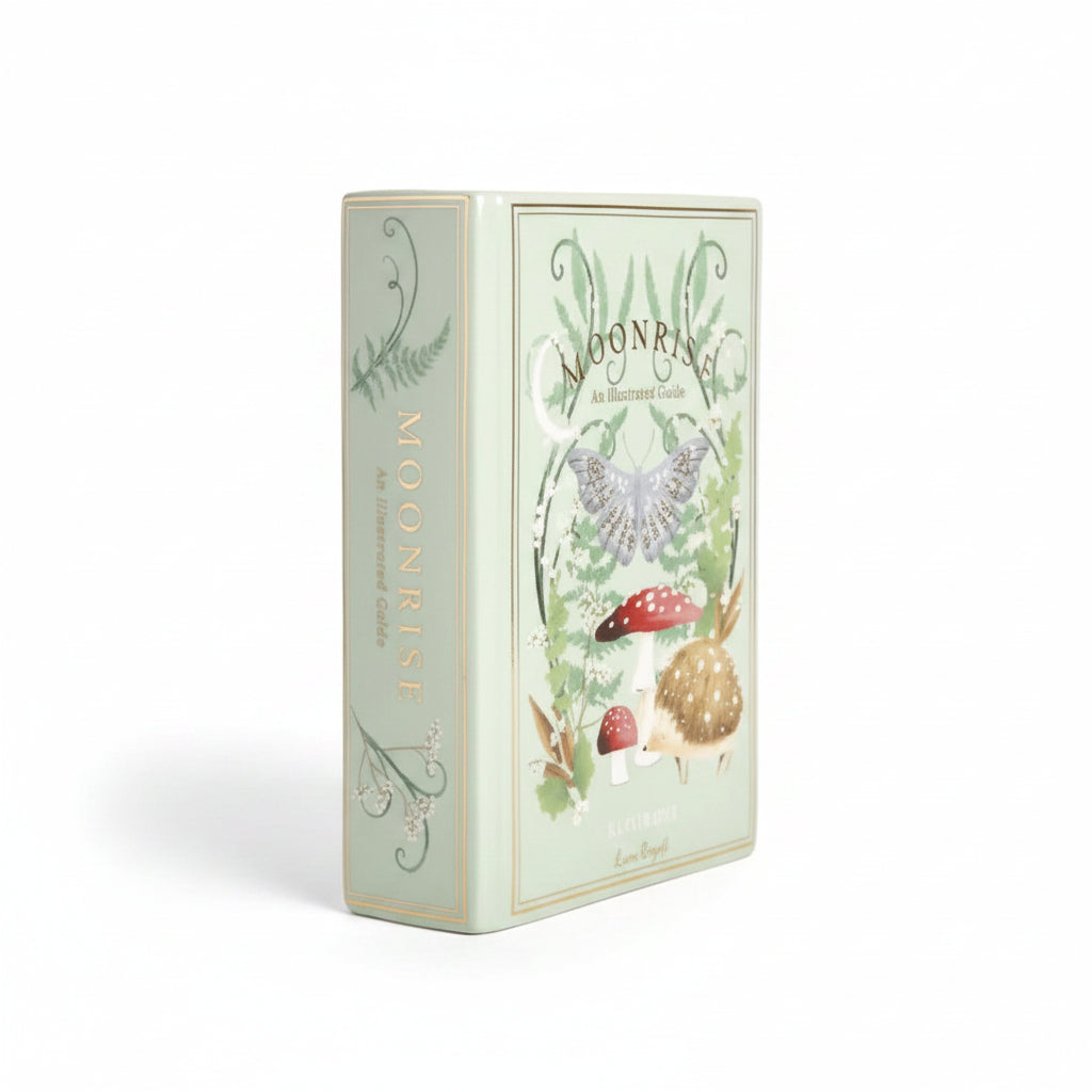Ceramic book vase angled view showing illustrated spine and front cover