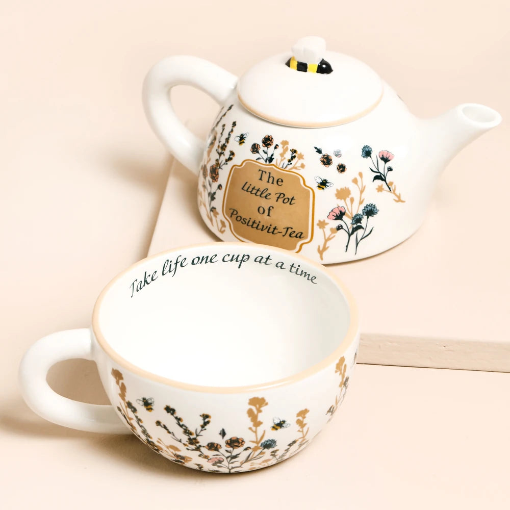 Teapot and cup separated, cup reading take life one cup at a time