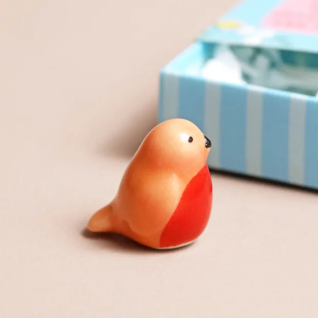 Close-up of hand-painted ceramic robin with red breast detail