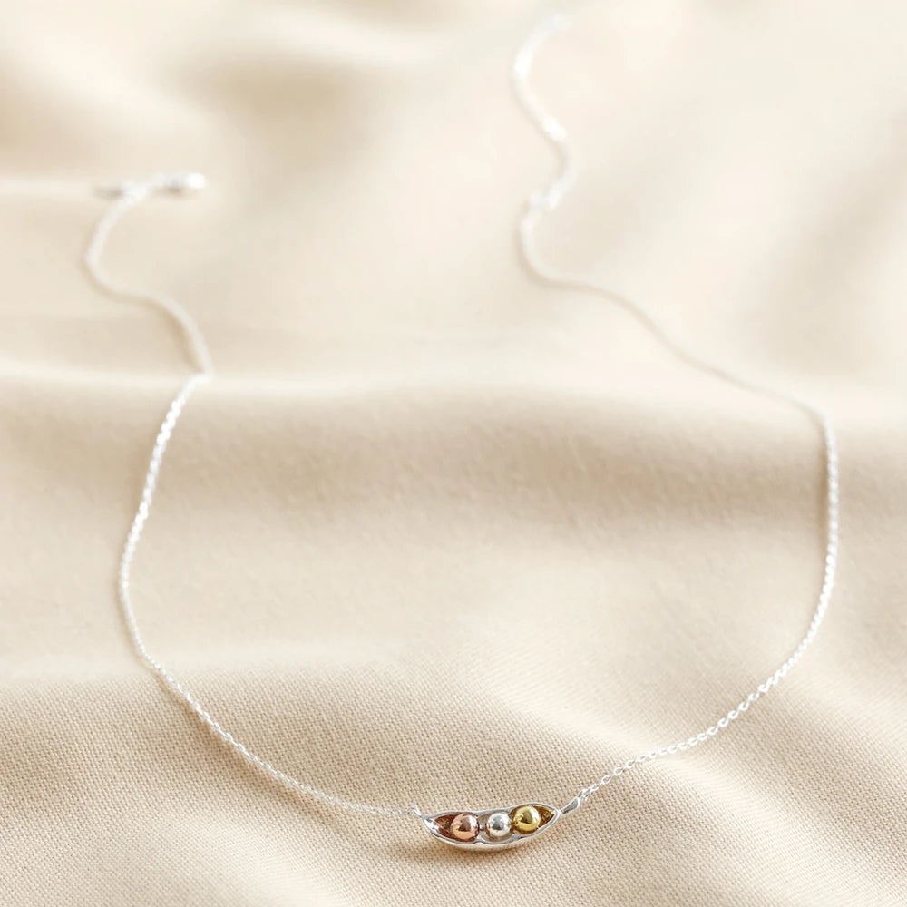 Full peas in a pod necklace with its fine silver trace chain laid out