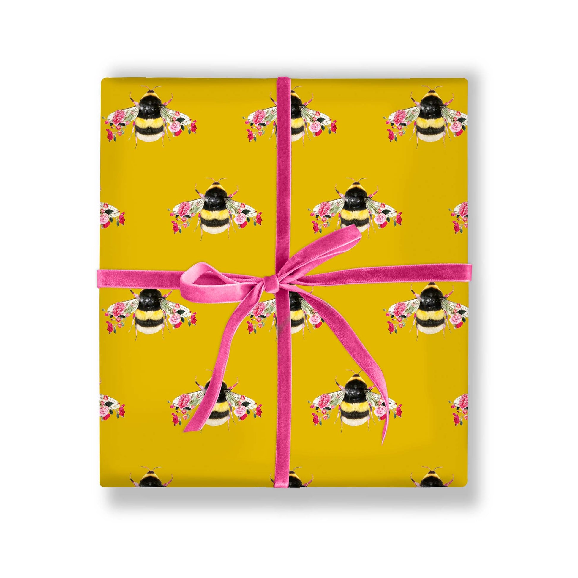Gift wrapped in botanical bee paper with ribbon