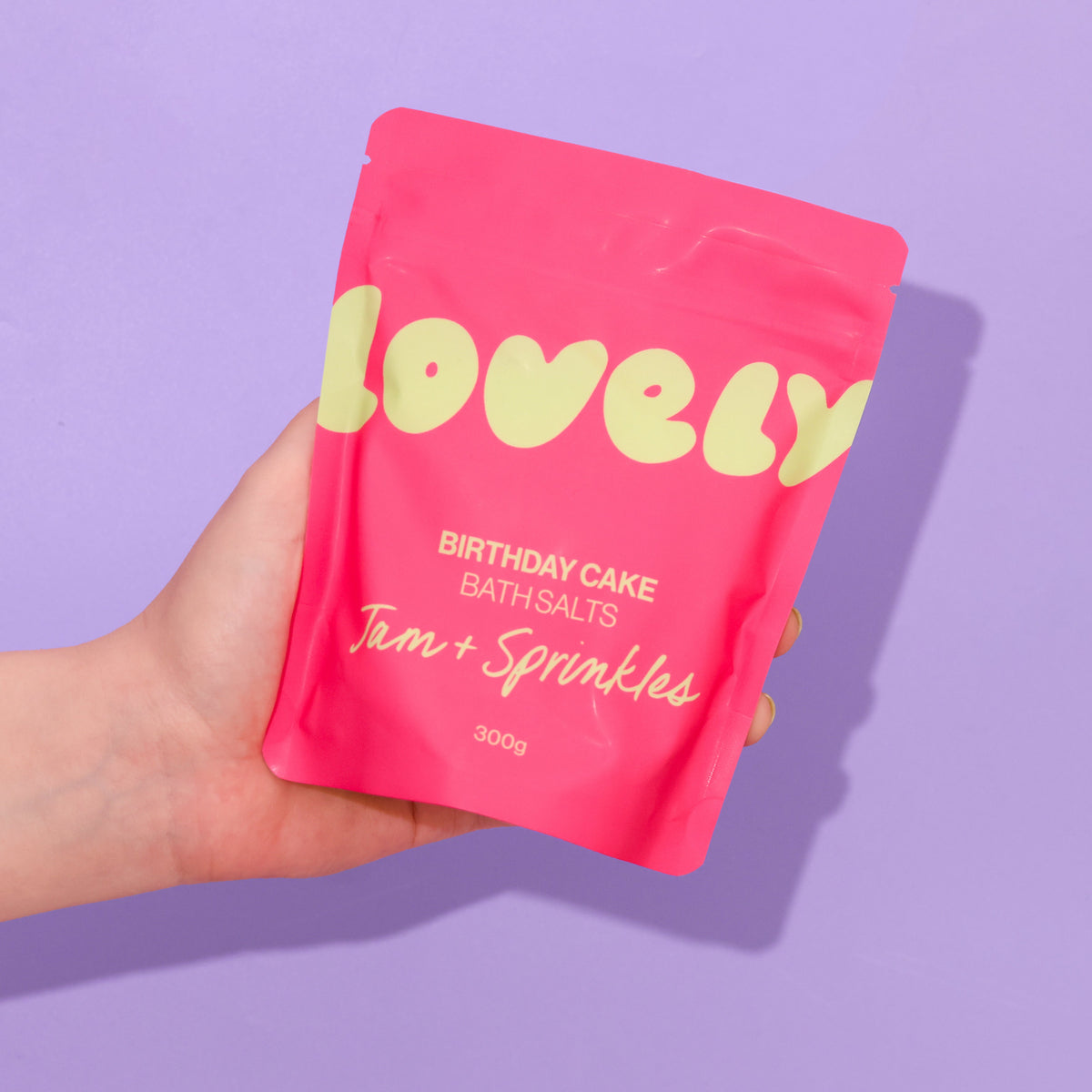 Hand holding the Birthday Cake bath salts pouch
