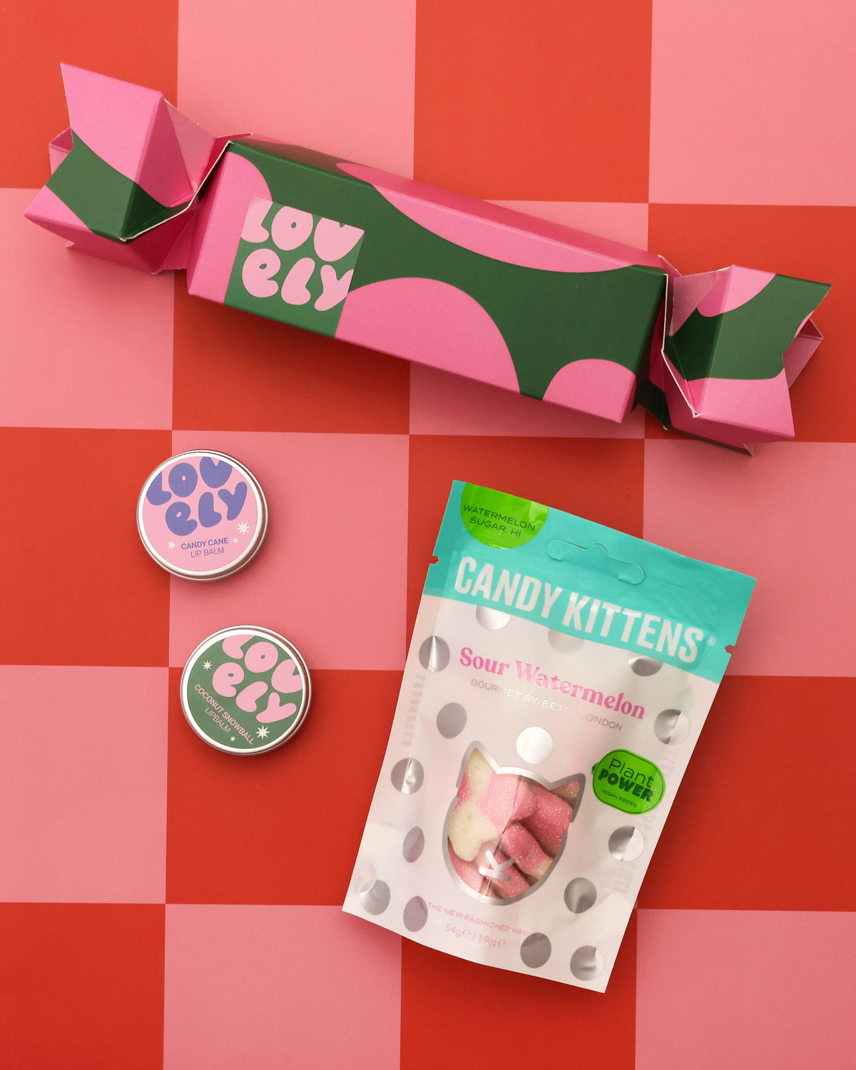 Christmas cracker, lip balms and sweets on red checks