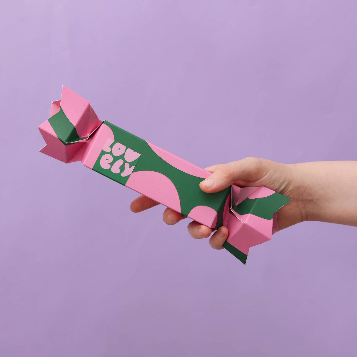 Hand holding the Lovely Skincare Christmas cracker