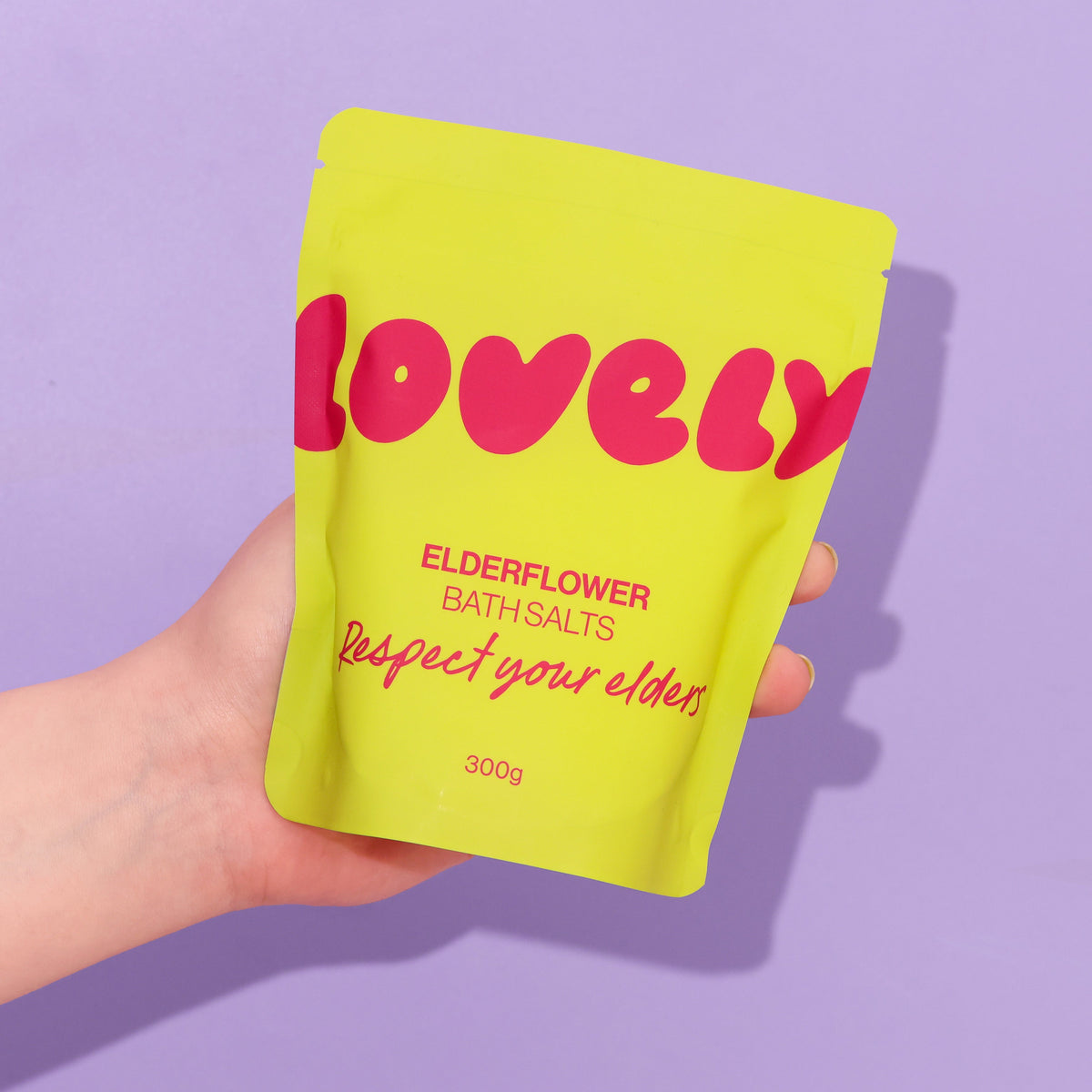 Hand holding the Elderflower bath salts pouch