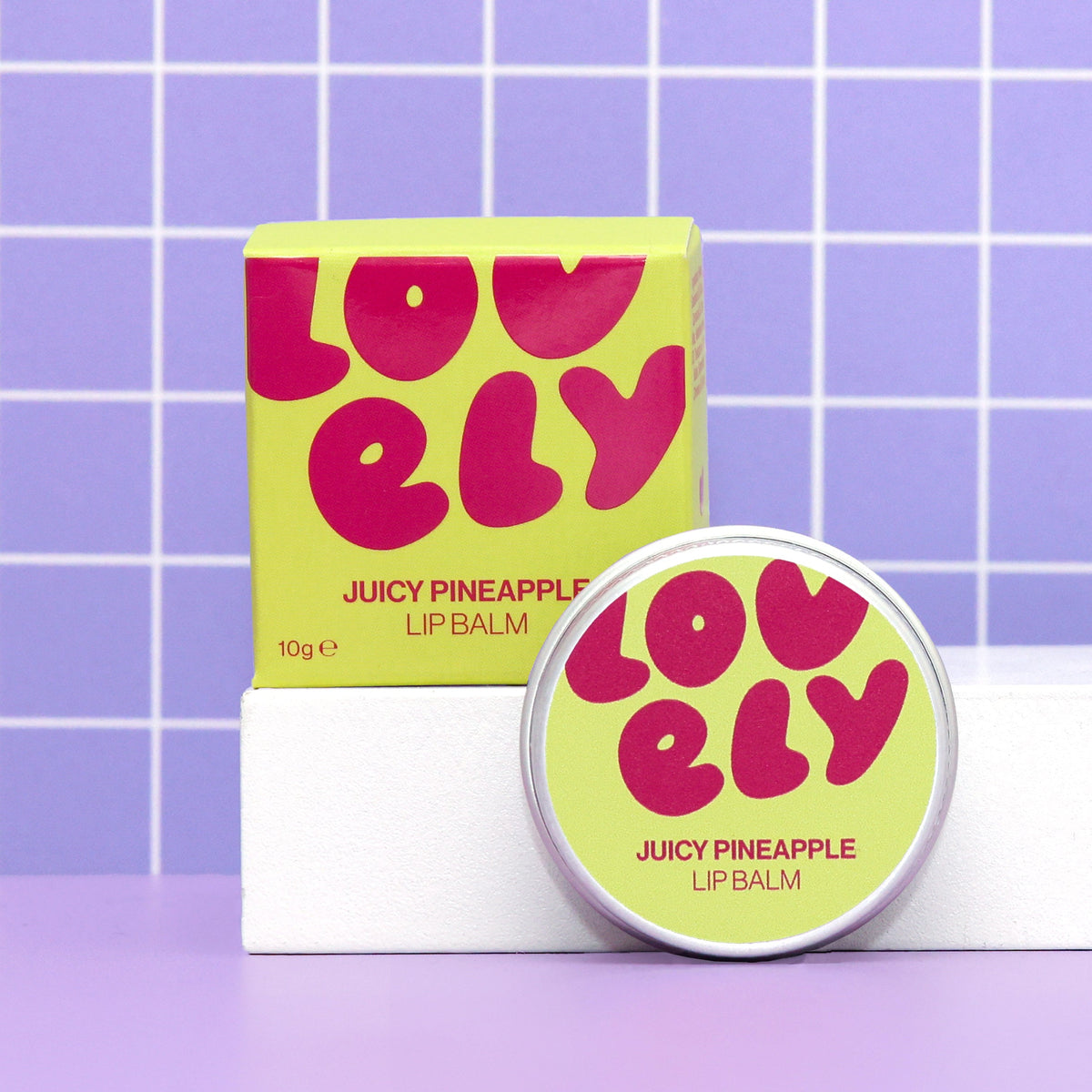 Juicy Pineapple lip balm tin and box by Lovely Skincare styled lifestyle view