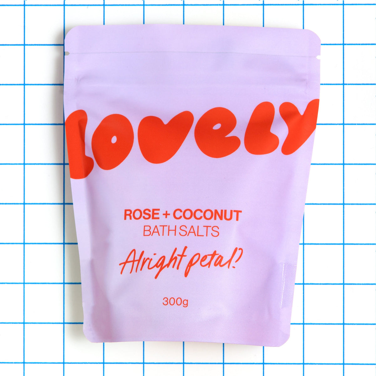 Rose and Coconut bath salts pouch on a blue grid