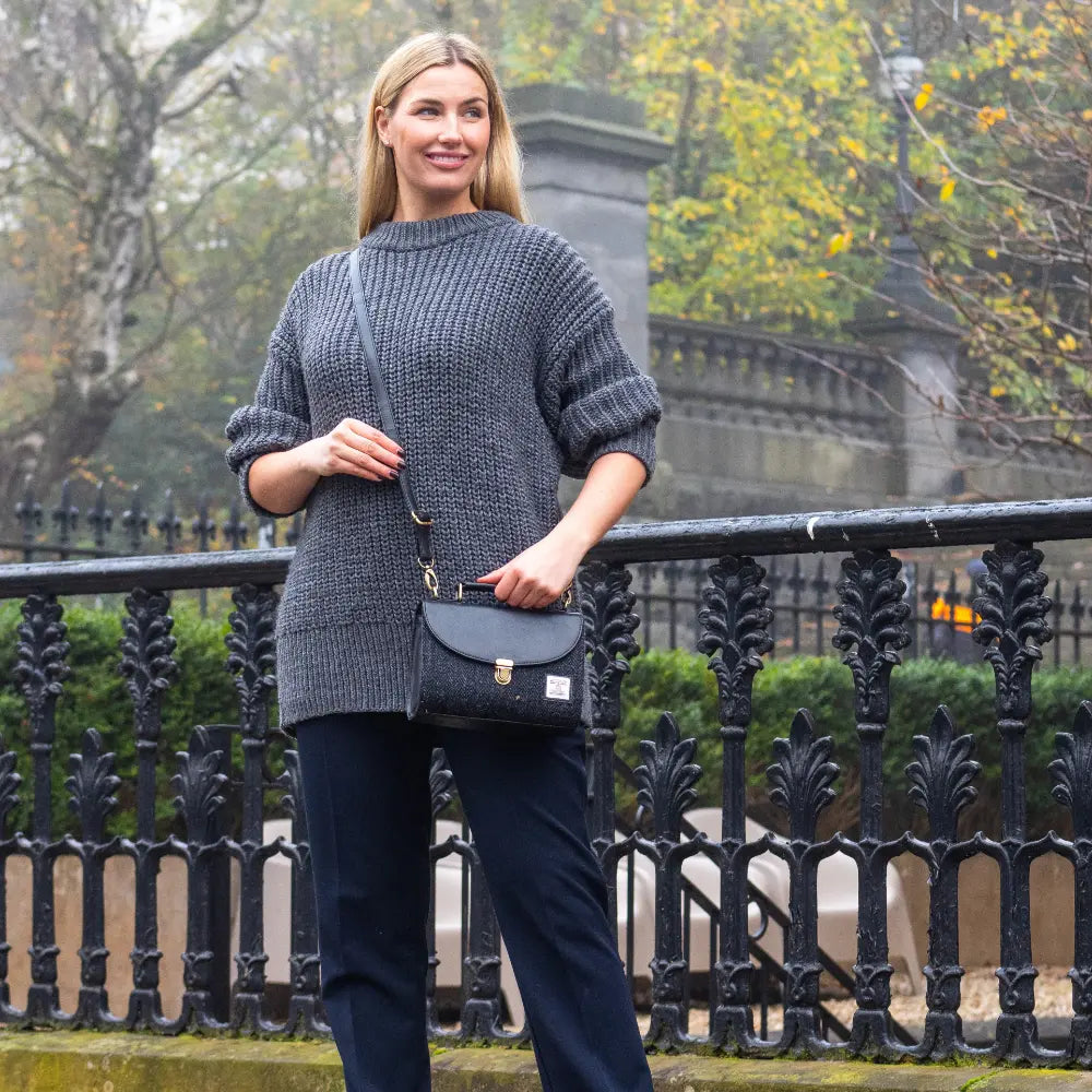 Charcoal Harris Tweed mini day bag worn across the body outdoors