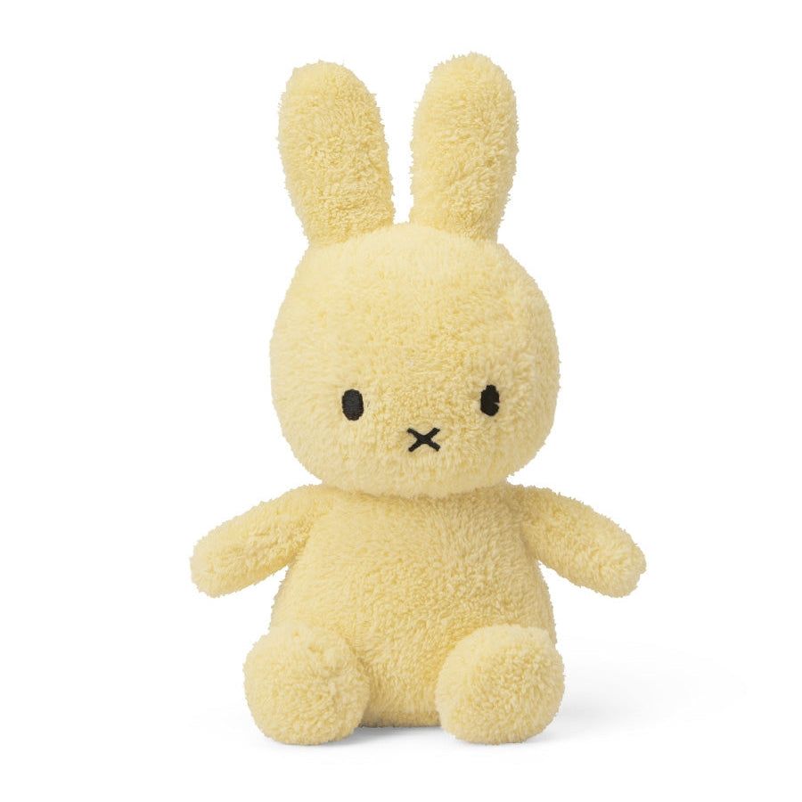 Miffy sitting terry towelling soft toy in light yellow, 23cm, front view on white background