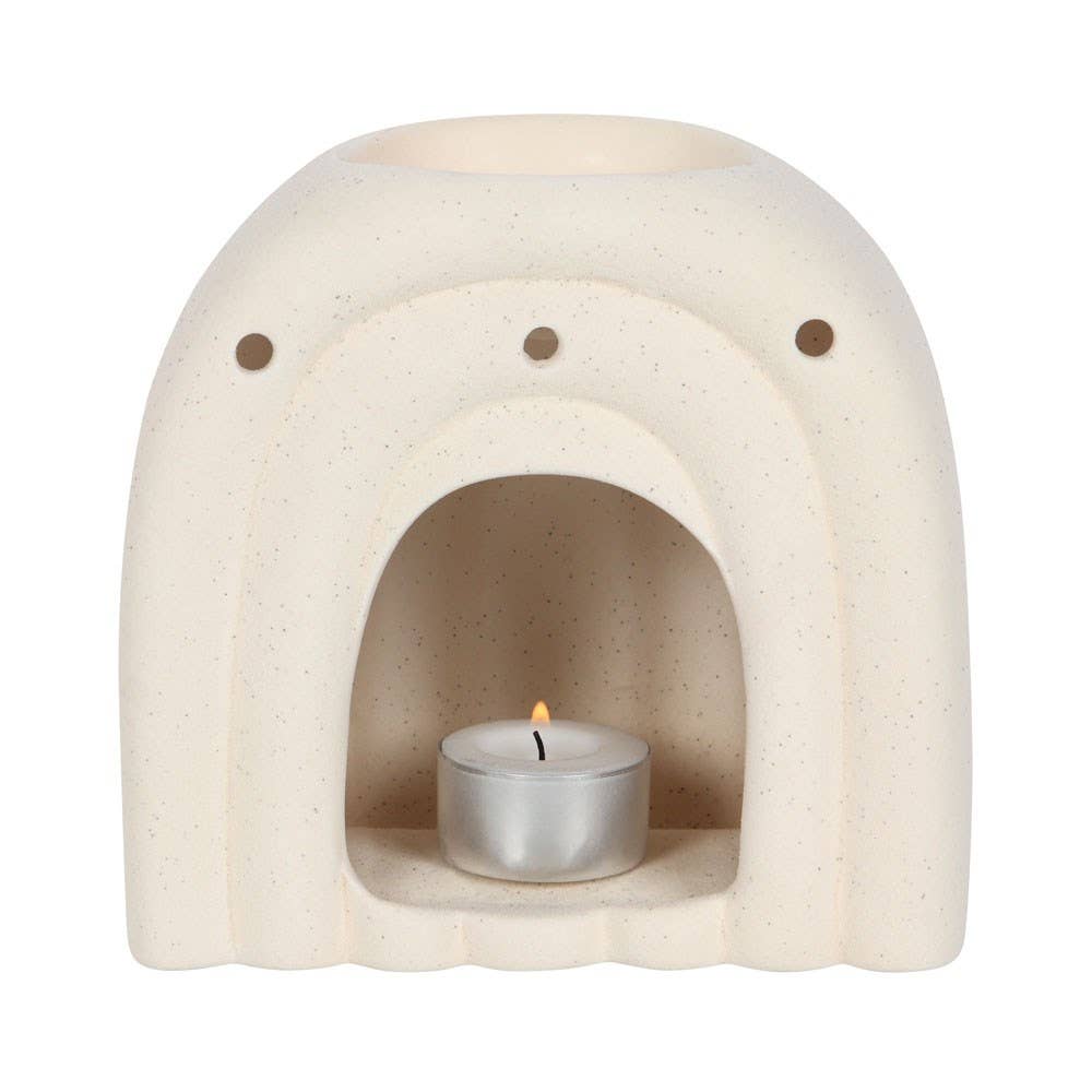 Minimalist arch wax warmer with lit tealight inside