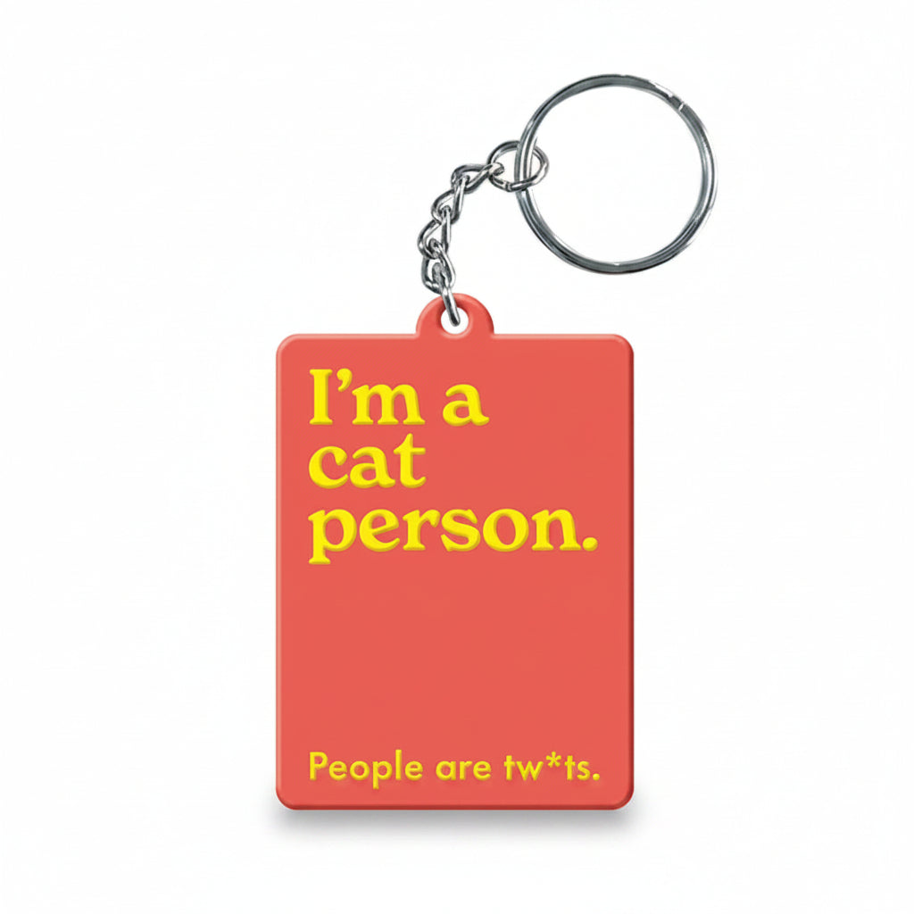 Cat person slogan keyring in coral on white background