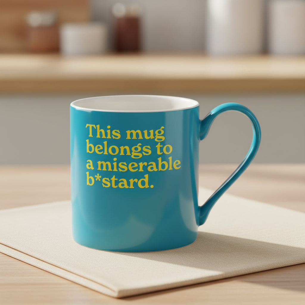 Bright blue Miserable B*stard mug shown side on against a plain white background