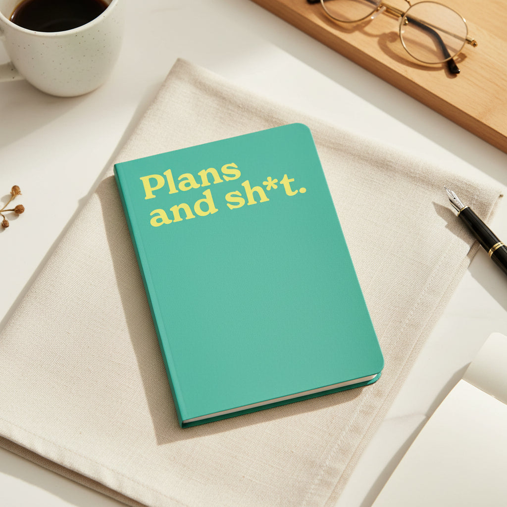 Plans and Sh*t neon A5 notebook shown flat on a white background