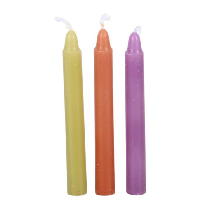 Mischief and Magic spell candles in a styled setting